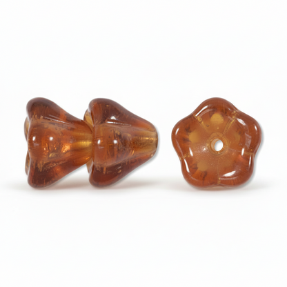 Two amber-brown translucent glass beads on a white background, one shown from the front and one from the top, both featuring a flared, ribbed design and a central hole.