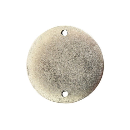 A round, textured metal wall plate or sign blank with two pre-drilled holes, shown on a solid white background.