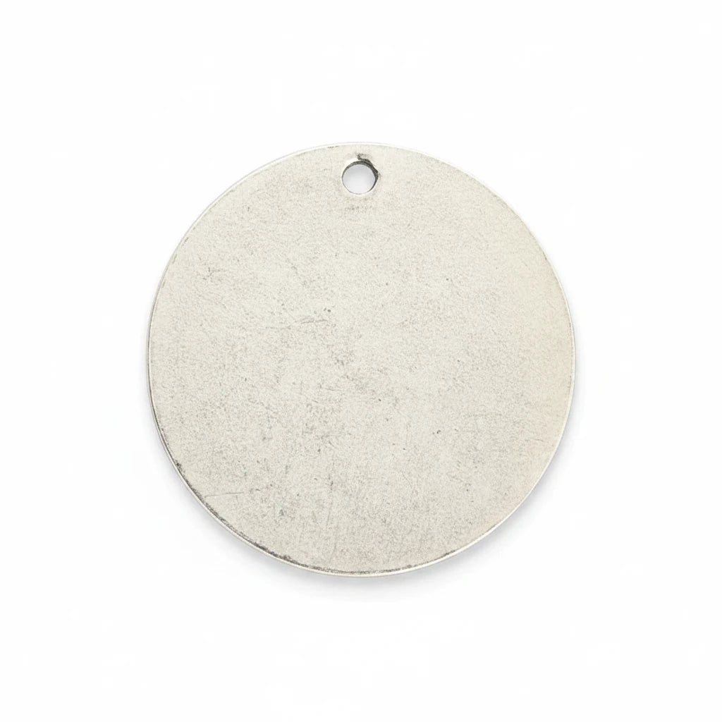 A blank, round silver metal tag with a small hanging hole at the top, shown on a solid white background.