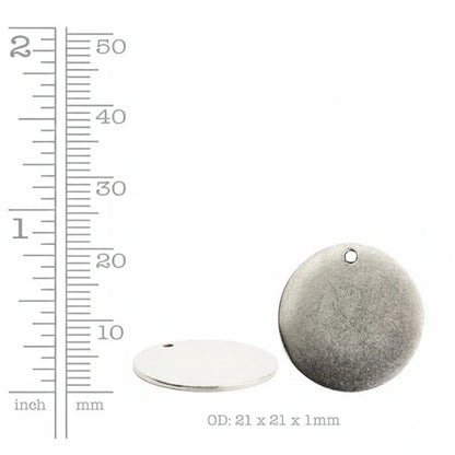 A round silver metal disc pendant with a pre-drilled hole, shown alongside a ruler scale on the left and a dimension label 'OD: 21 x 21 x 1mm' at the bottom, on a plain white background.