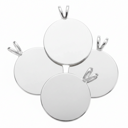 Four blank round silver pendants with bail loops, arranged in a fan-like cluster on a solid white background.