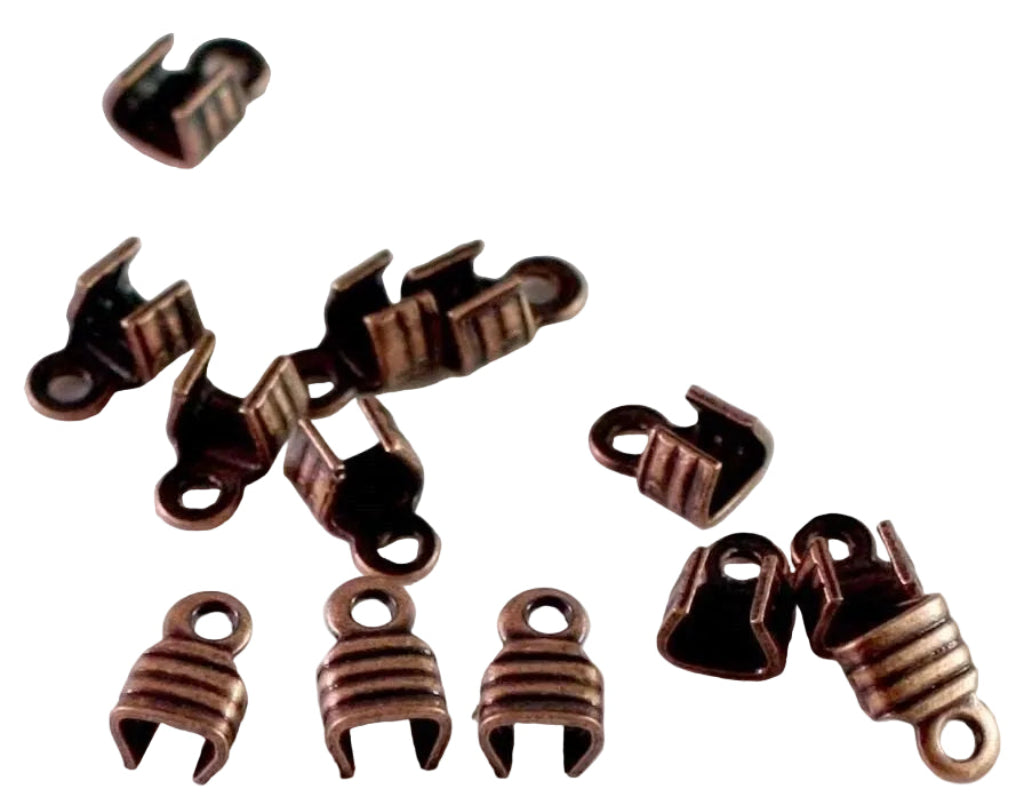 A group of small metal jewelry findings or clasp components in a copper or bronze-toned finish, arranged on a plain light background.