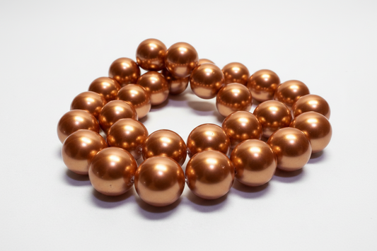 A strand of metallic bronze-colored round beads arranged in a loose coil on a plain white background.