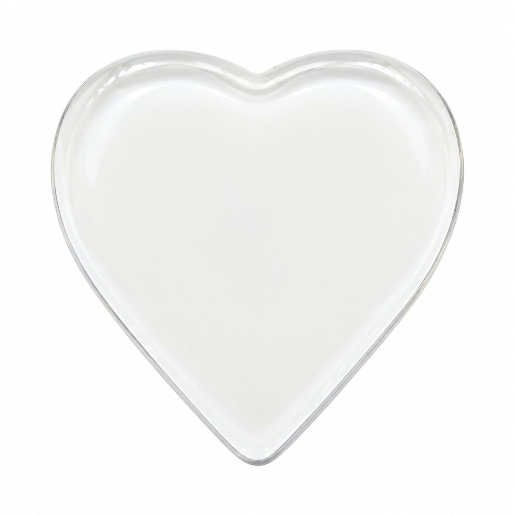 A small, heart-shaped white ceramic dish or tray with a shallow depth of field, shown against a plain white background.