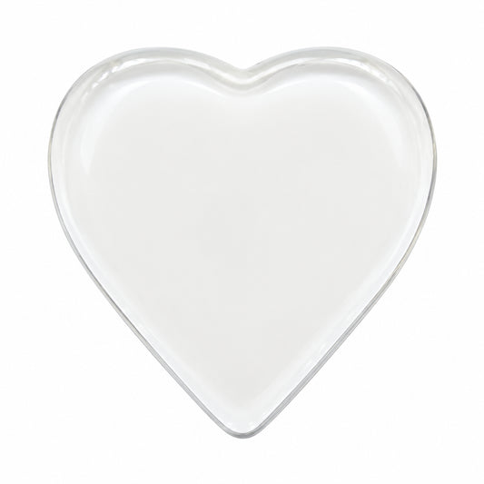 A small, heart-shaped white ceramic dish or tray with a shallow depth of field, shown against a plain white background.