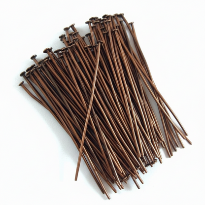A bundle of long, thin brown metal cable ties with flat heads, arranged on a plain white background.