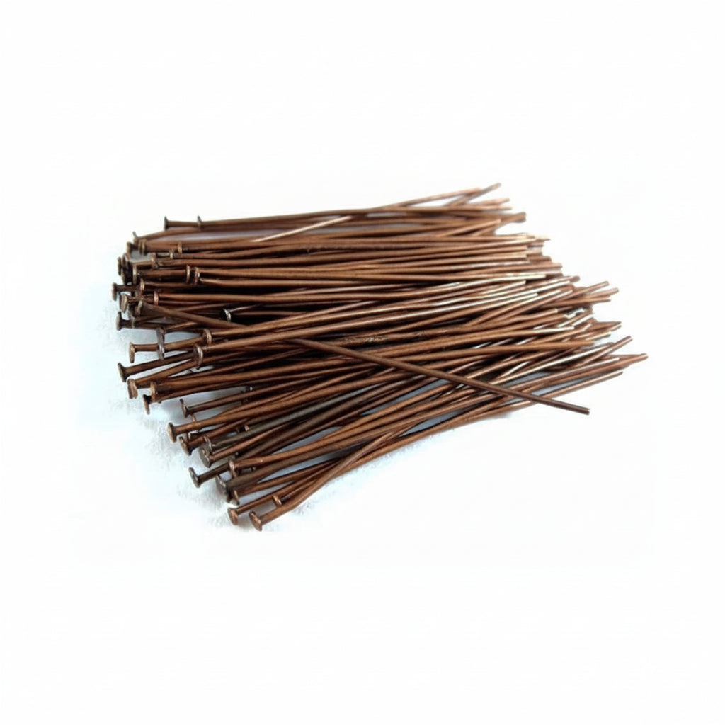 Pile of bronze-colored metal stakes on a white background
