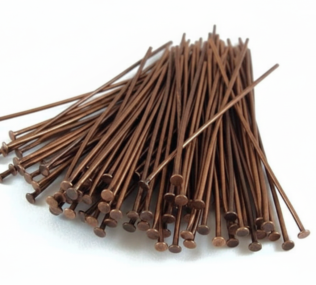 A pile of brown metal nails with round heads, arranged on a plain white background.