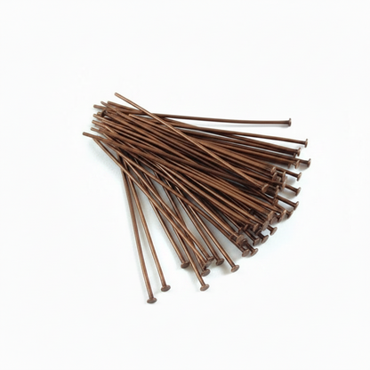 A pile of COPPER HEAD PINS with metal spring clips, arranged on a clean white background.