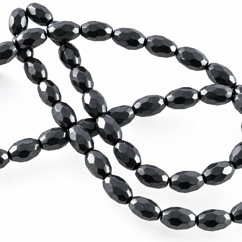 Faceted black glass beads on a plain white background.