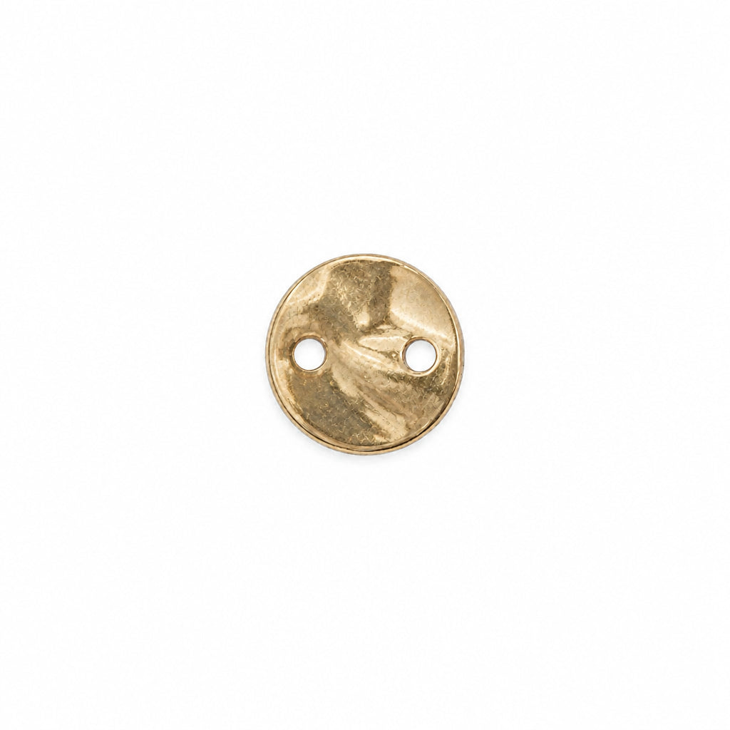 A small round gold metal disc with two pre-drilled holes, shown on a plain white background.