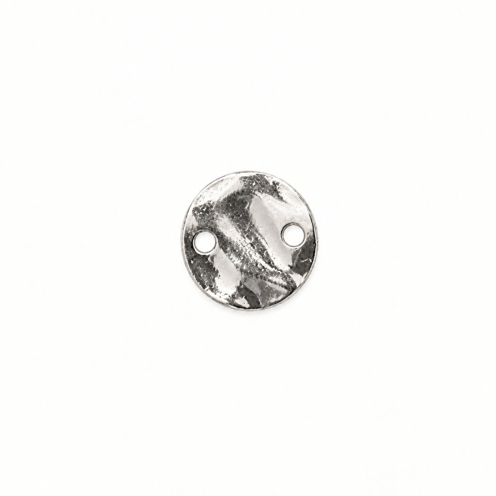 A small round silver metal disc with two pre-drilled holes, shown on a plain white background.