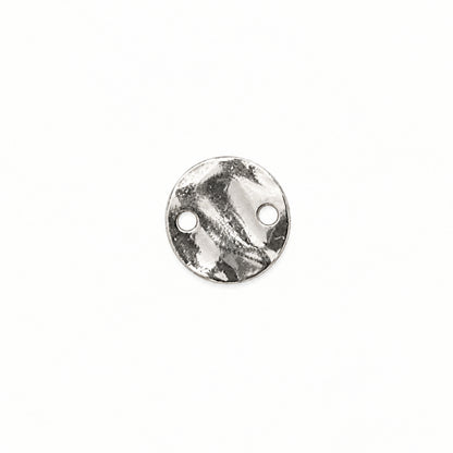 A small round silver metal disc with two pre-drilled holes, shown on a plain white background.