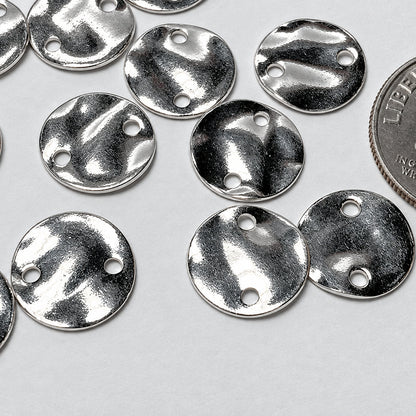 Several small round silver metal disc charms with three pre-drilled holes, shown on a light gray background with a U.S.