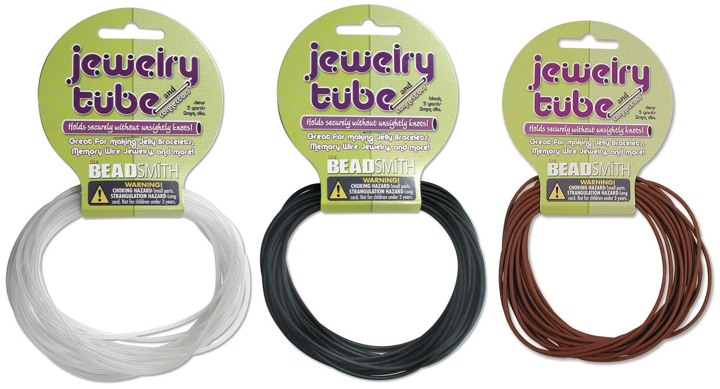 Three packages of 'jewelry tube' with white, black, and brown cord on a white background.