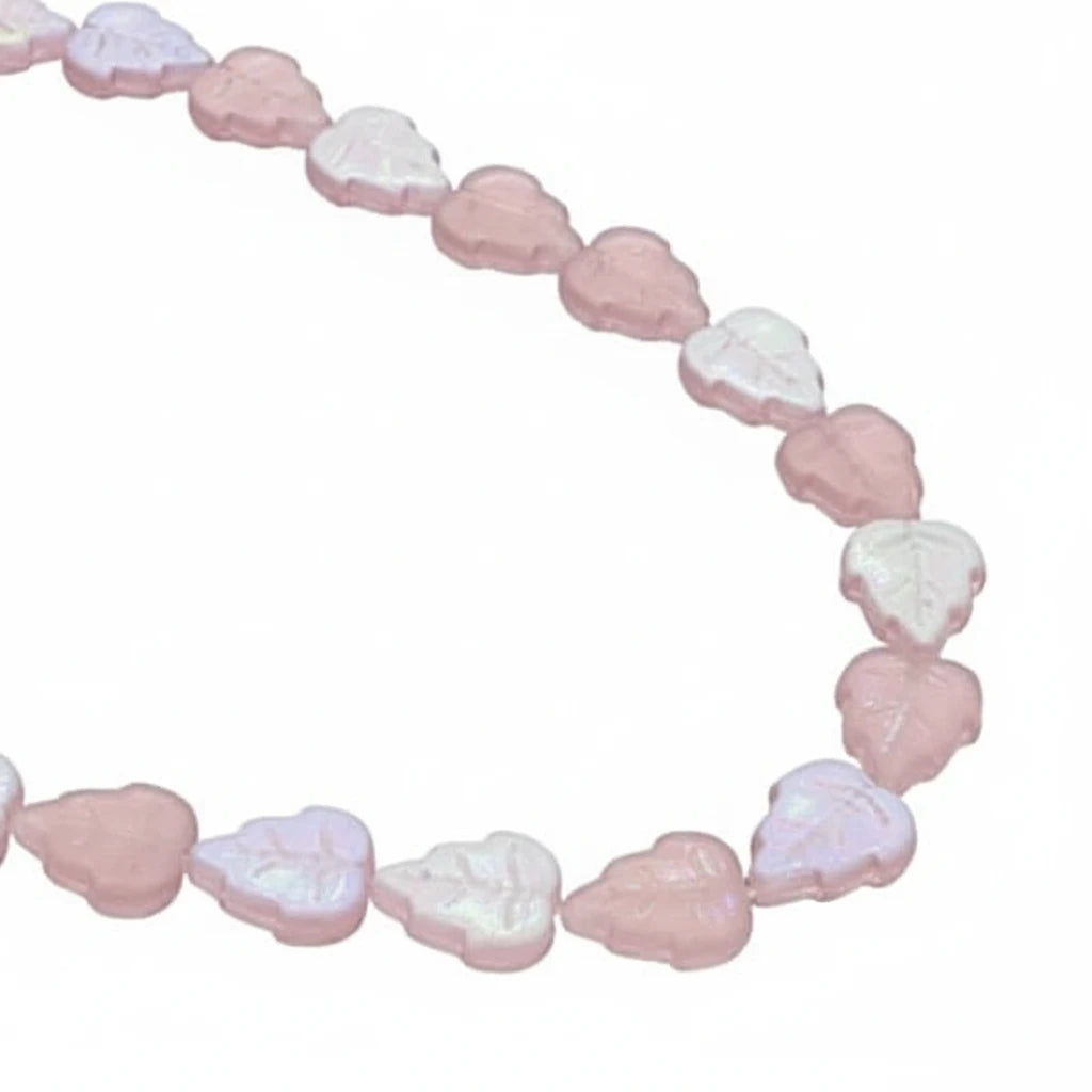 A strand of heart-shaped beads in pastel shades of pink, lavender, and white, arranged in a curved line against a plain white background.