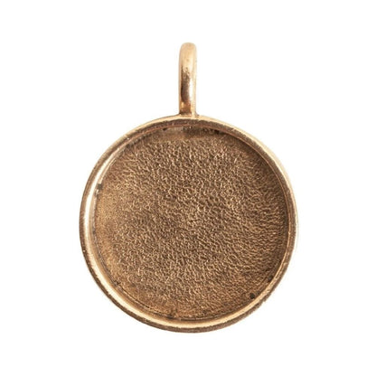 A round, bezel-set gold pendant or charm blank with a textured center and a small top loop, shown on a plain white background.