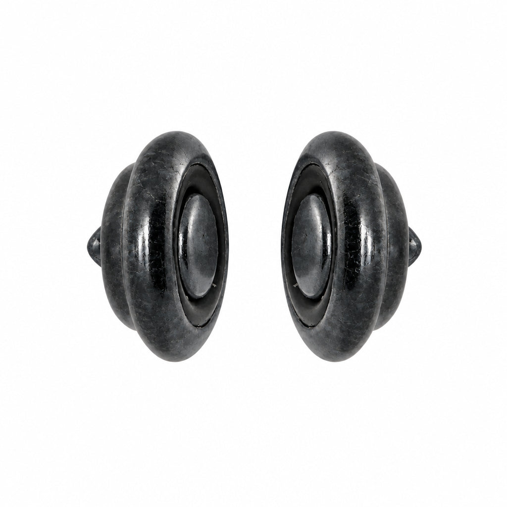A pair of dark gray metallic round CLASP with a central oval cutout, shown against a plain white background.
