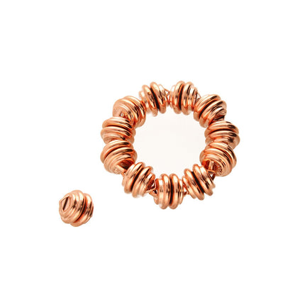 A copper on a plain white background, with one smaller loose coil placed to the lower left.