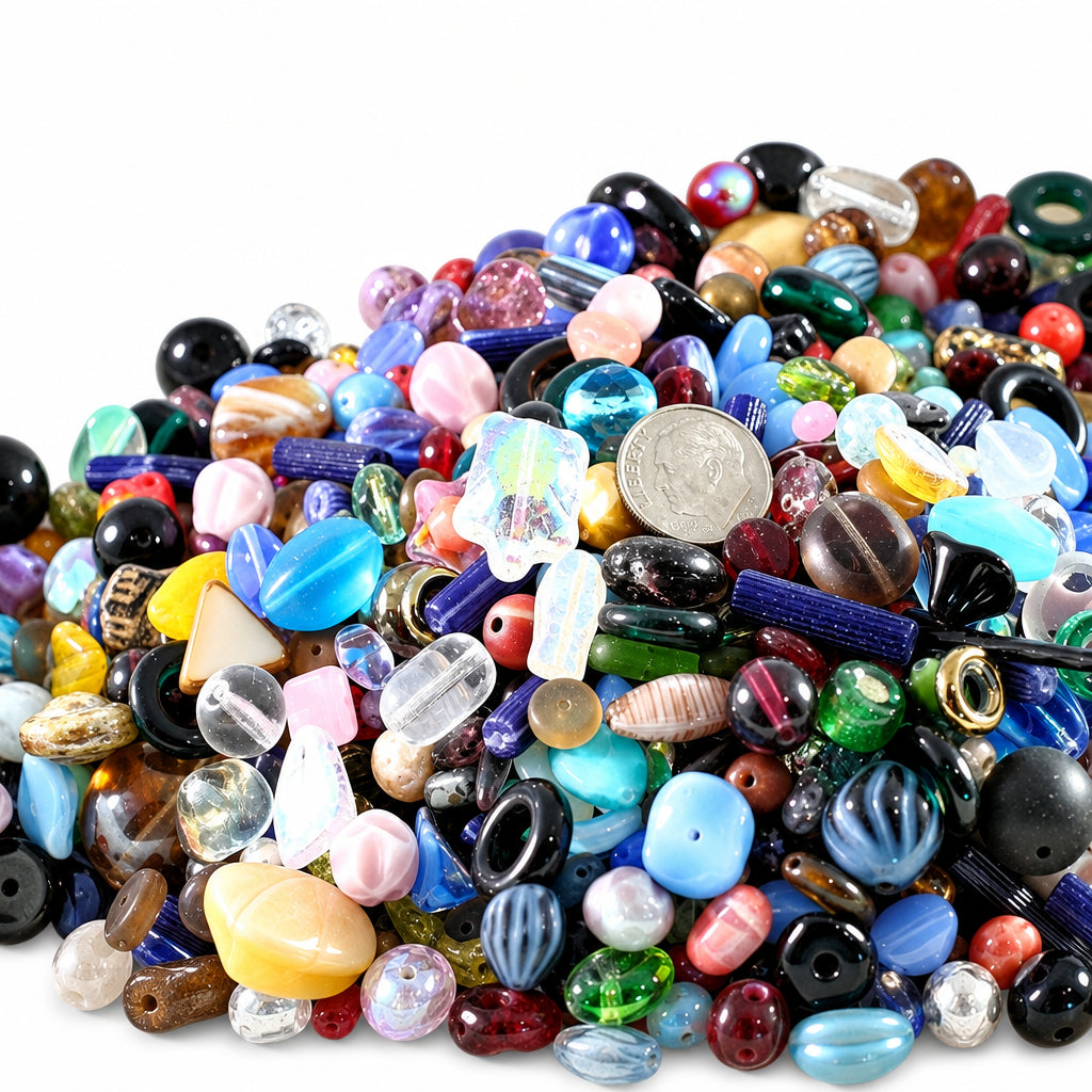 A large pile of assorted colorful glass beads and small jewelry components on a plain white background.