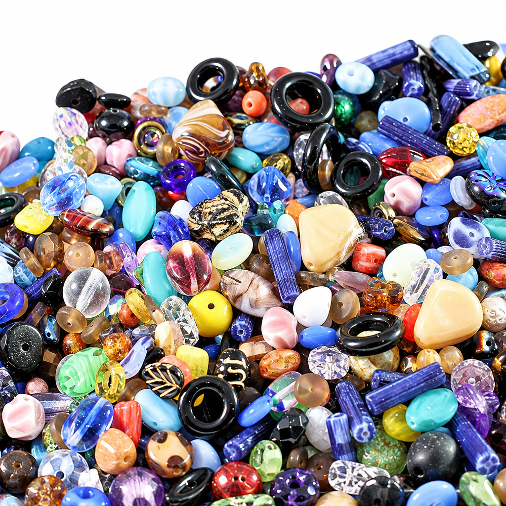 A dense pile of assorted colorful glass beads and stone chips in various shapes, sizes, and translucent finishes, filling the frame.