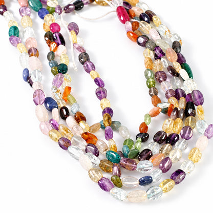 Multiple strands of polished multicolor gemstone beads draped on a plain white background.