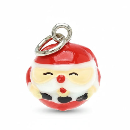 A Santa Claus face charm with a red and white body, yellow cheeks, black facial features, and a silver metal ring at the top, shown on a plain white background.