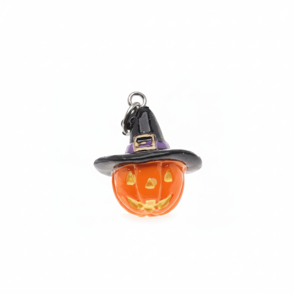 A small Halloween charm shaped like a carved orange pumpkin wearing a black witch hat with a purple band and gold buckle detail, attached to a silver ring on a plain white background.