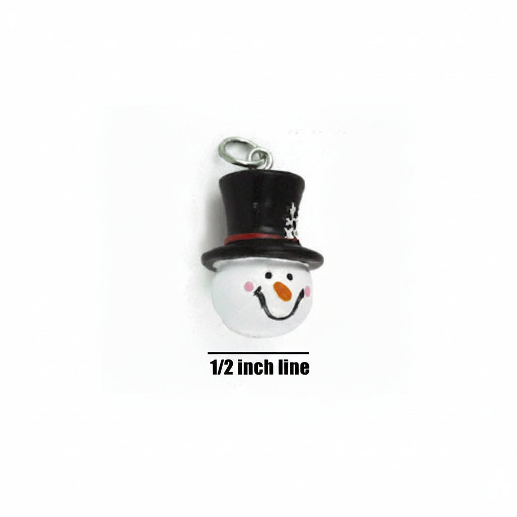 A small snowman charm or pendant with a black top hat, white face, pink cheeks, orange carrot nose, and a silver hanging loop, shown on a white background with a 1/2 inch line for scale.