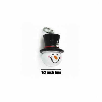 A small snowman charm or pendant with a black top hat, white face, pink cheeks, orange carrot nose, and a silver hanging loop, shown on a white background with a 1/2 inch line for scale.