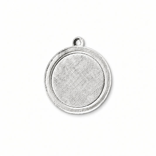 A round silver-toned metal pendant or charm blank with a textured center and a small loop at the top, shown on a plain white background.