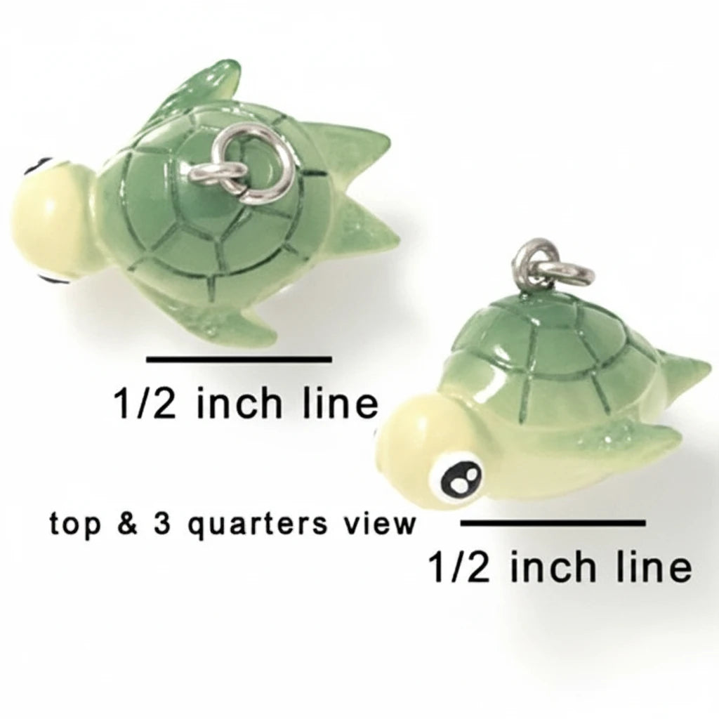 Two small turtle-shaped charms shown on a white background with measurement labels reading 1/2 inch line and top & 3 quarters view.