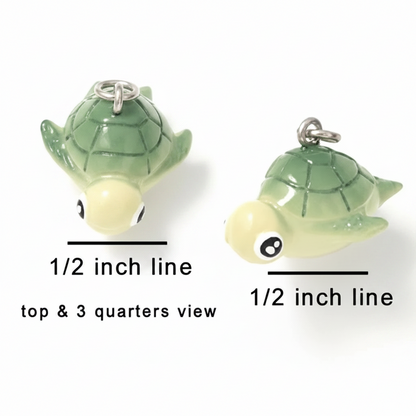 Two small turtle charms shown on a white background with measurement labels reading 1/2 inch line and top & 3 quarters view, to indicate size.