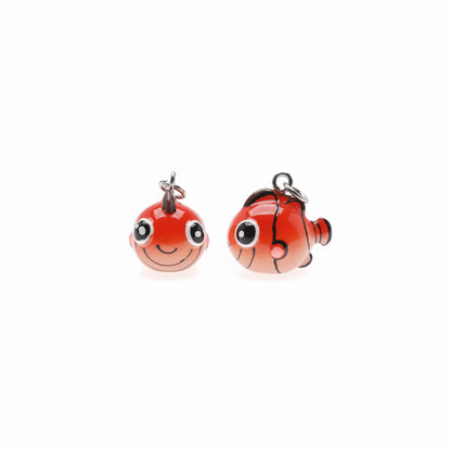 Two small red clownfish-shaped charms with black stripes, white eyes, and silver hanging loops on a plain white background.