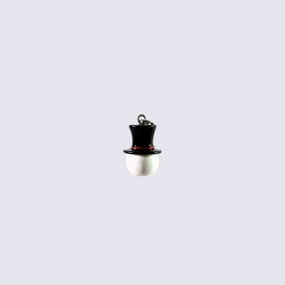 A small novelty pendant shaped like a snowman, featuring a glossy black top hat with a thin red band and a white spherical body, centered on a light gray background.