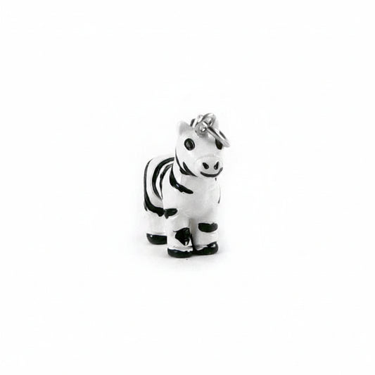 A small zebra charm or pendant with black and white stripes, featuring a silver metal ring at the top, shown on a plain white background.