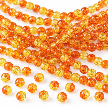 Multiple strands of translucent orange-yellow round beads with a silver coin and black ruler for scale on a white background.