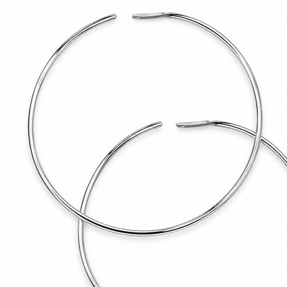 Two thin silver metal hoop earrings overlapping on a plain white background.