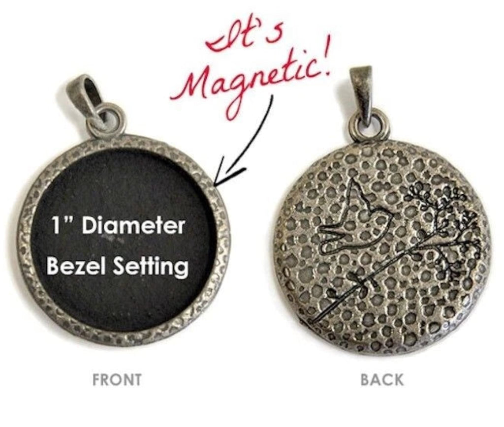 A round bezel-set pendant shown from both front and back on a white background. The front side is black with white text reading '1" Diameter Bezel Setting,' and the back side shows an antiqued silver-toned textured surface with a small engraved design.