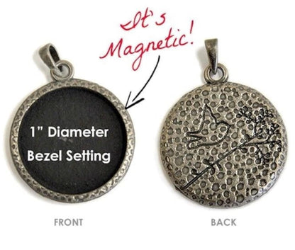 A round bezel-set pendant shown from both front and back on a white background. The front side is black with white text reading '1" Diameter Bezel Setting,' and the back side shows an antiqued silver-toned textured surface with a small engraved design.