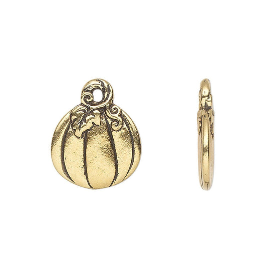 A gold-toned pumpkin-shaped jewelry charm shown from the front and side on a plain white background.
