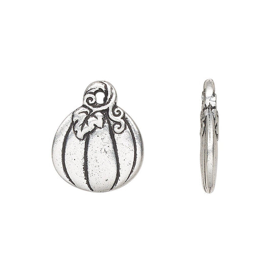 An antique silver pumpkin-shaped charm shown from two angles: a front view displaying a ribbed pumpkin design with a stem and leaf, and a side profile view showing the loop back.