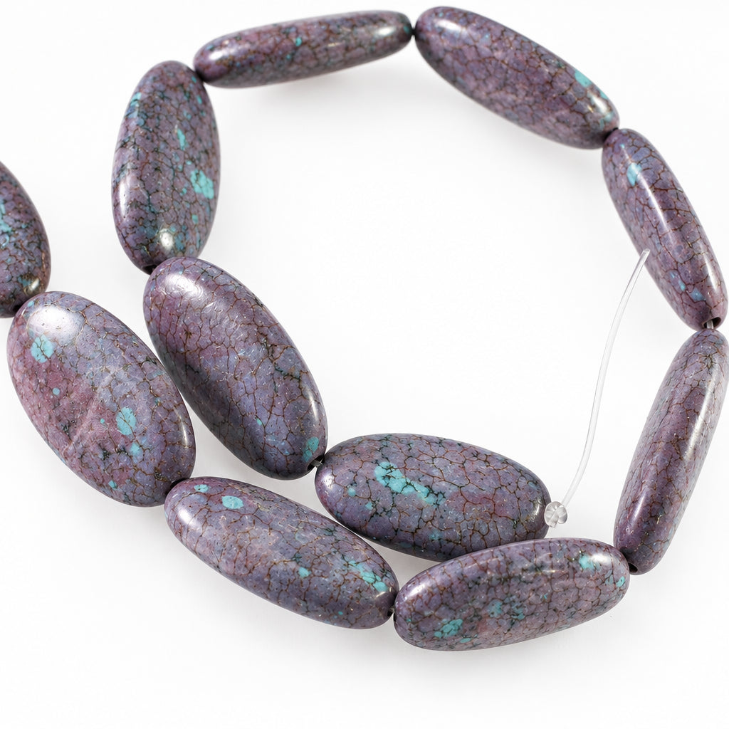 A strand of polished oval beads made from a purple marbled stone with bright turquoise blue matrix inclusions, displayed on a plain white background.