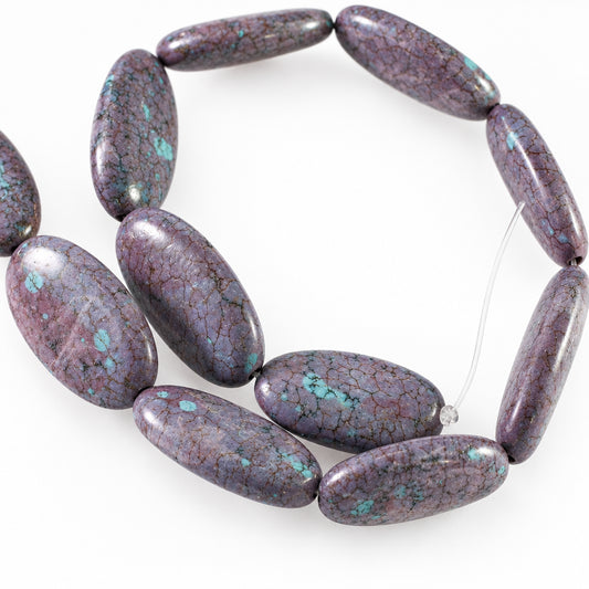 A strand of polished oval beads made from a purple marbled stone with bright turquoise blue matrix inclusions, displayed on a plain white background.