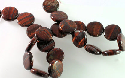 A strand of polished dark brown tiger's eye beads with natural striated patterns, arranged on a plain white background.