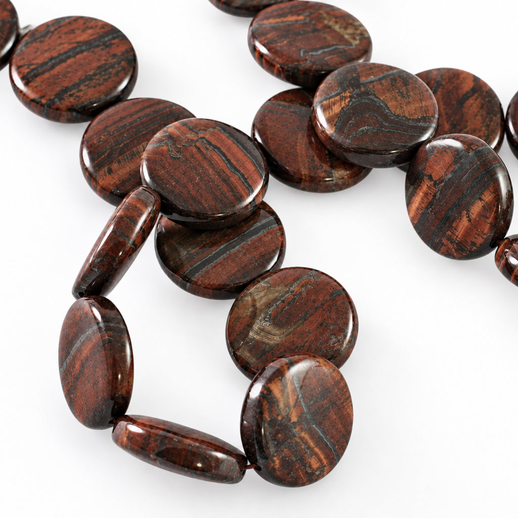 Round polished brown beads with a tiger's eye pattern, arranged on a light gray background.