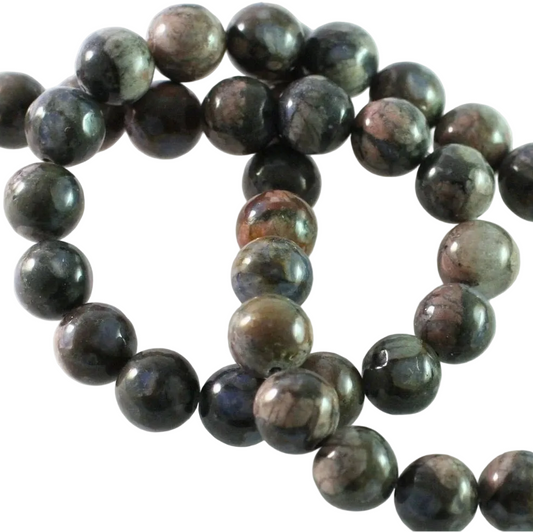 A strand of polished round gemstone beads in dark gray, black, and brown with natural marbled patterns, arranged on a plain white background.