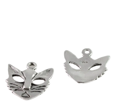 Two small silver metal charms shaped like animal faces, shown on a plain white background with a coin above them for scale.
