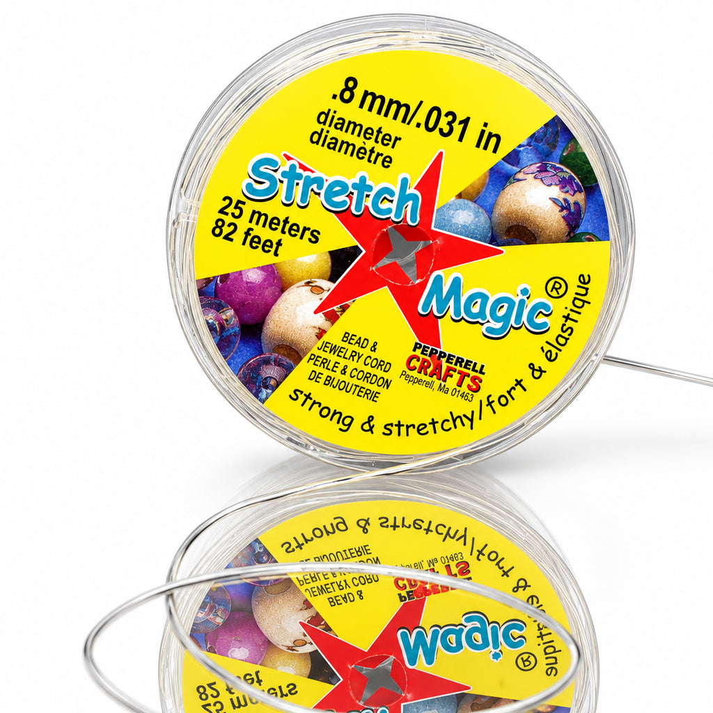 A spool of Magic Stretch Cord by Craftmall Crafts, featuring a yellow label with a red star logo and text detailing the .8 mm diameter and 25 feet length, shown on a reflective black surface.