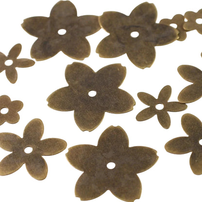 A set of brass flower-shaped craft beads with a single hole in the center, displayed on a plain white background.